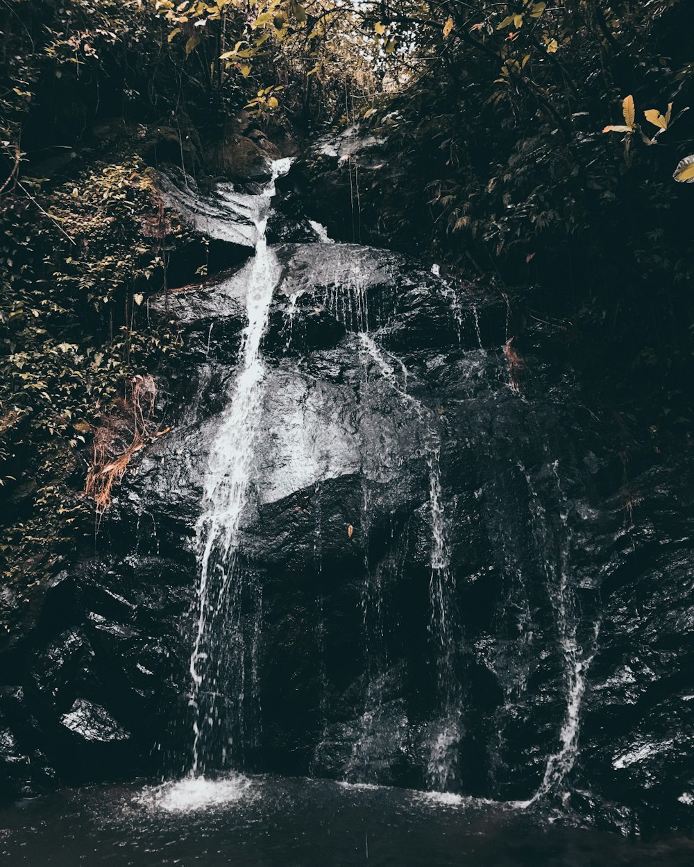 waterfalls with black stones