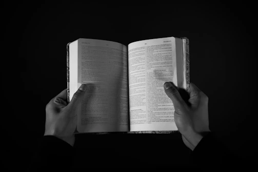 Close-up of hands holding a freshly printed book with the Ben Loudermilk Publishing logo on the cover.