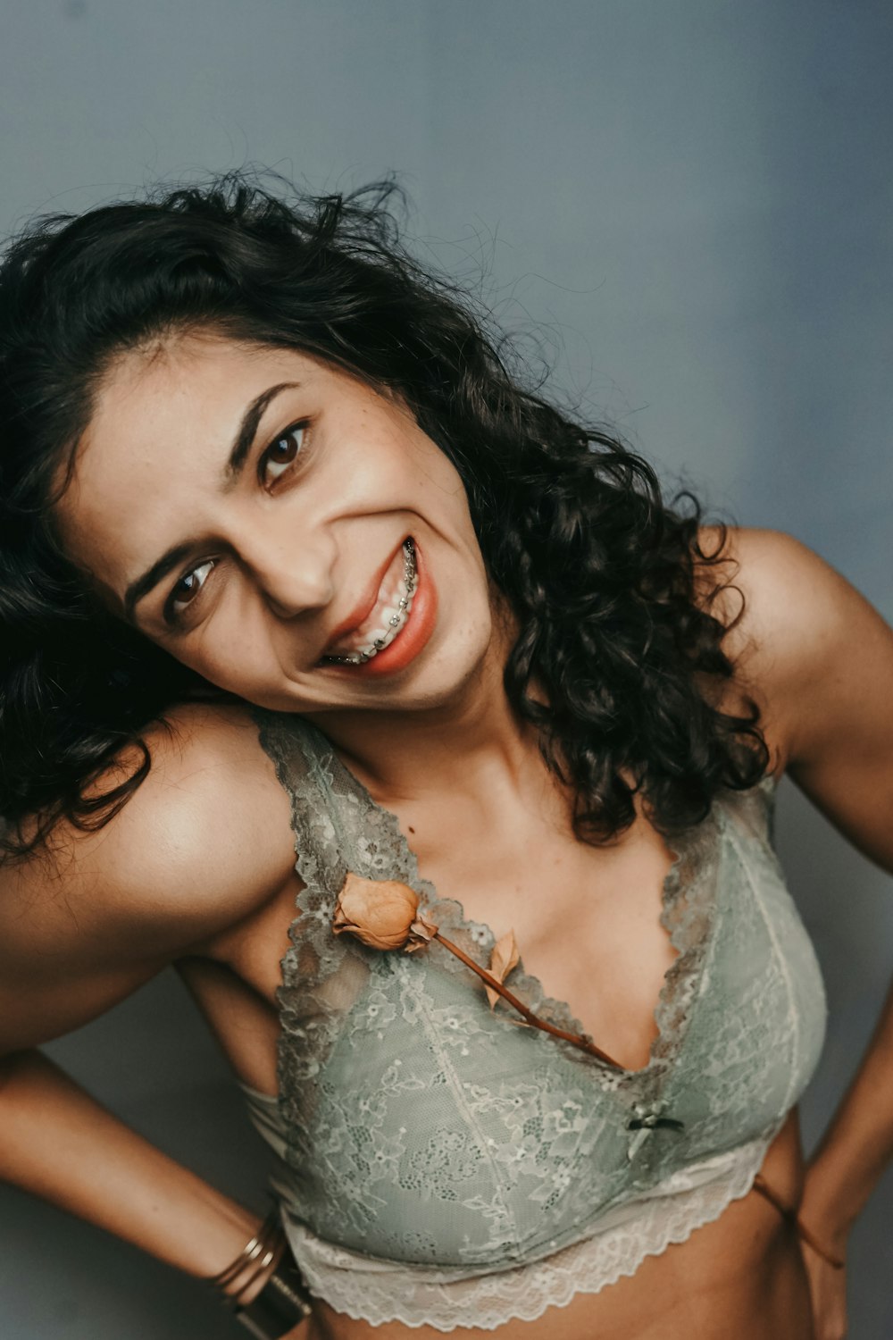 smiling woman wearing gray brassiere