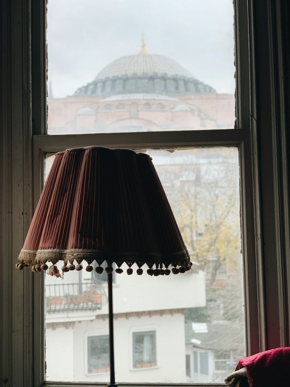 brown and black table lamp near the window