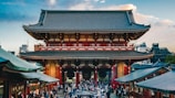 crowd of people in front of pagoda temple during daytime