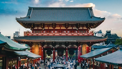 crowd of people in front of pagoda temple during daytime