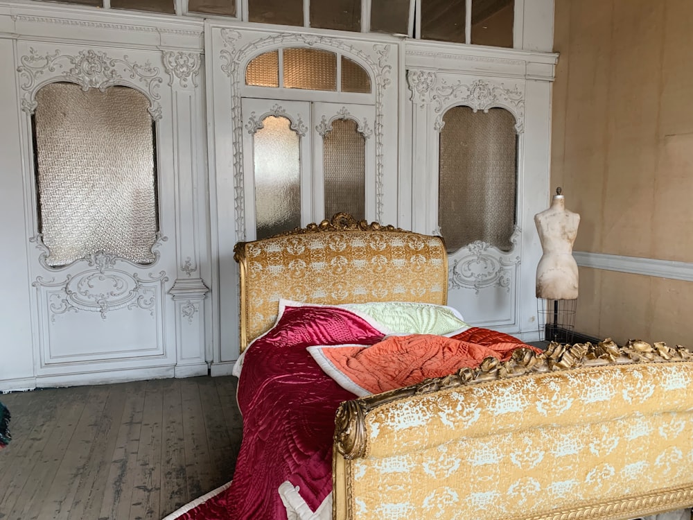 brown floral bed frame and red comforter