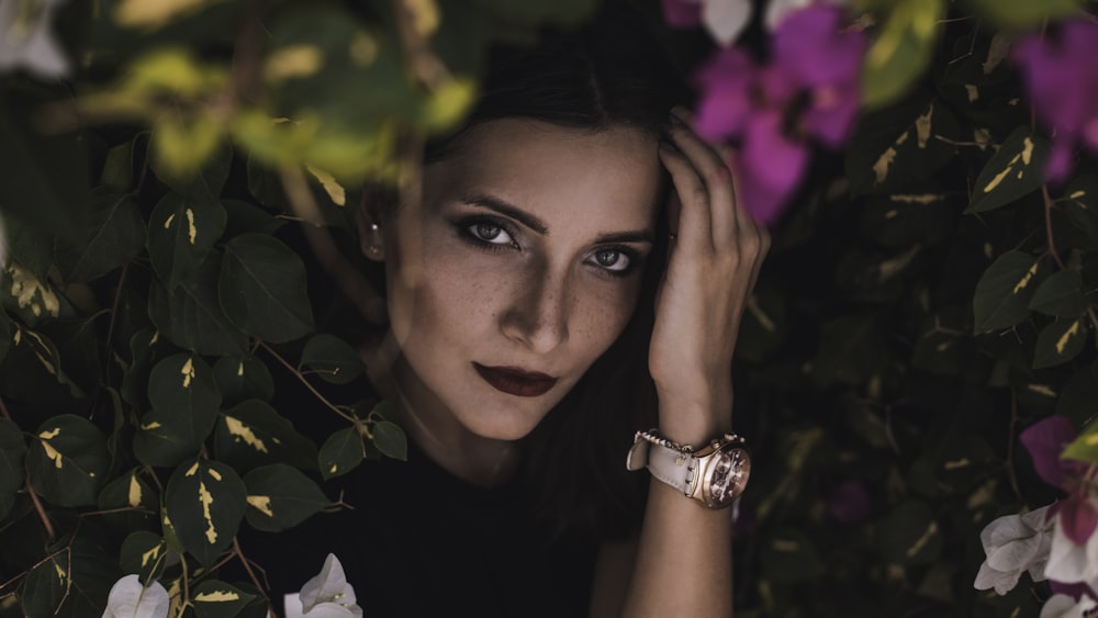 woman standing between plant