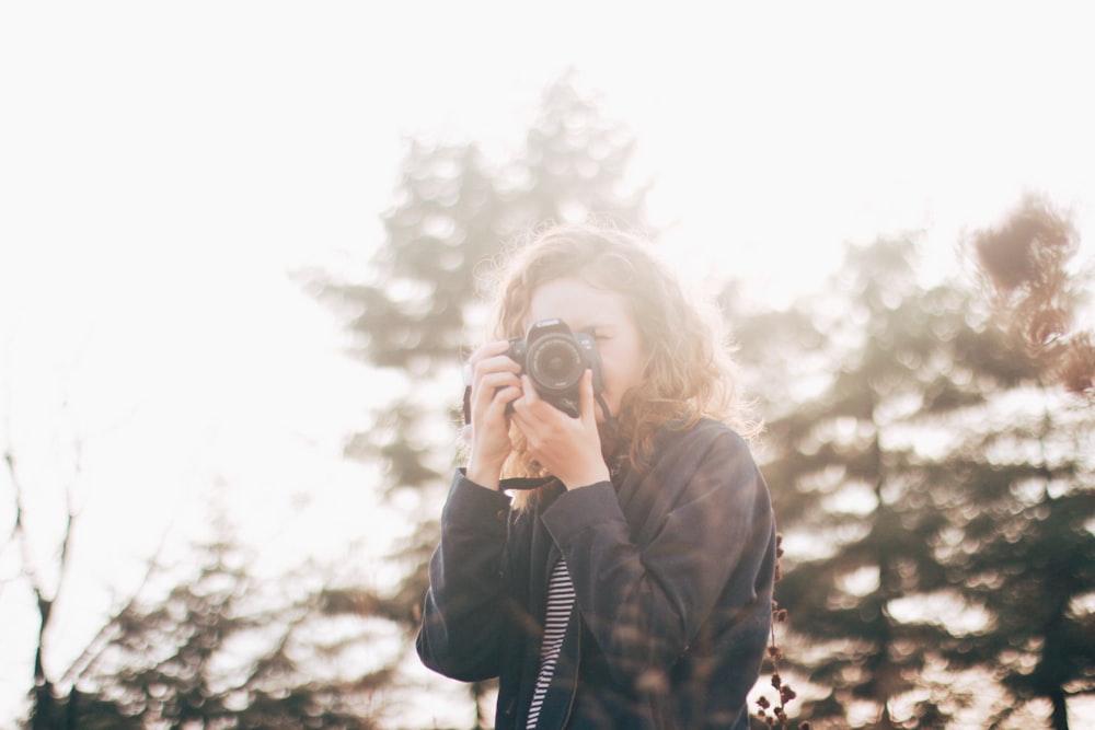 woman using DSLR camera