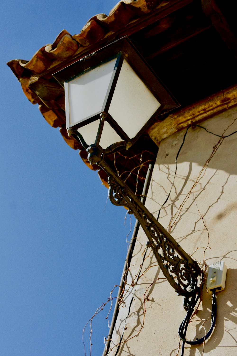 white and black outdoor sconce during daytime