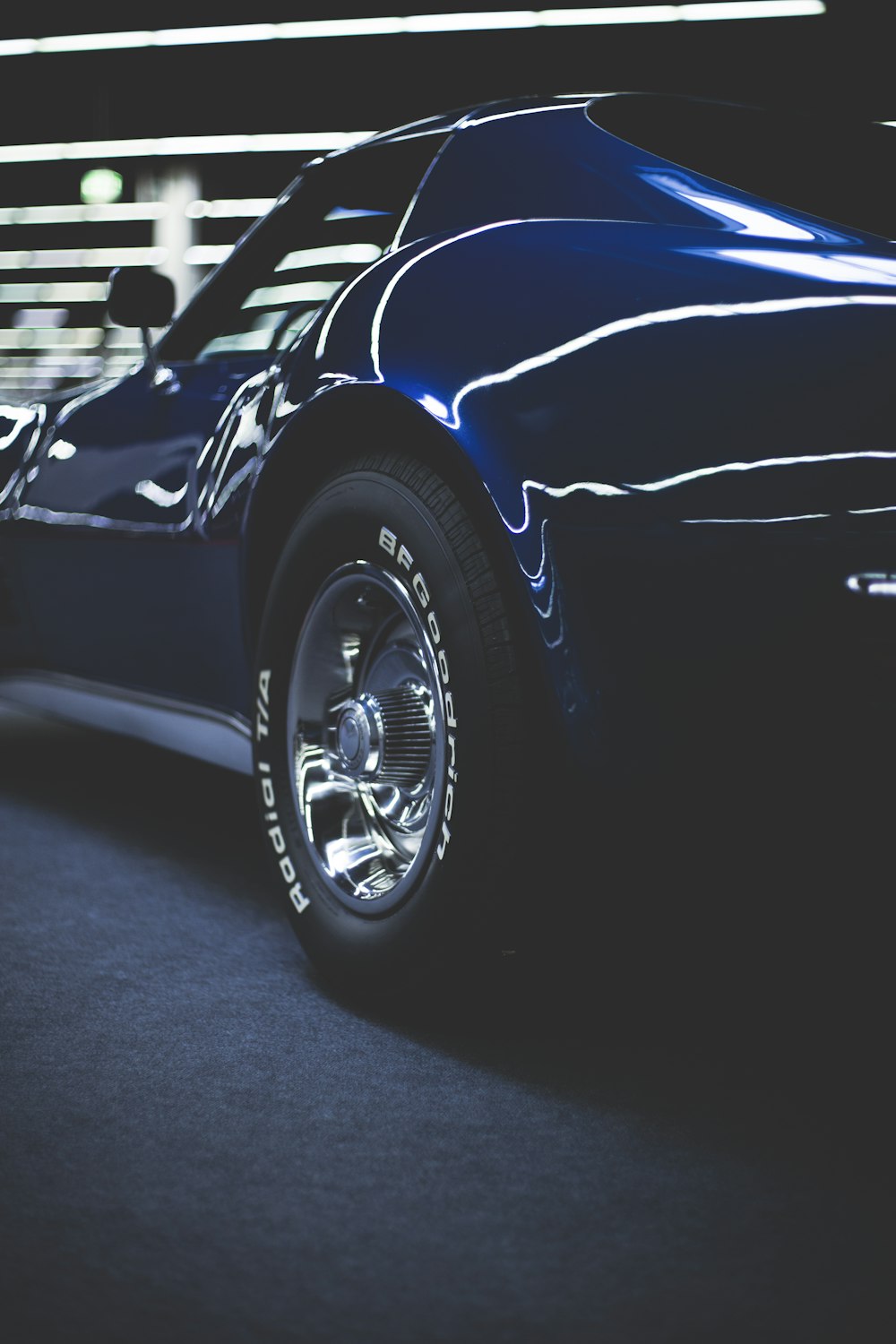 blue coupe on gray concrete pavement