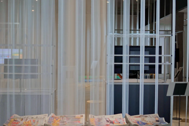 A sleek modern newsroom with journalists working on computers and large screens displaying breaking news.