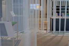 A minimalist design studio with screens displaying block templates in progress.