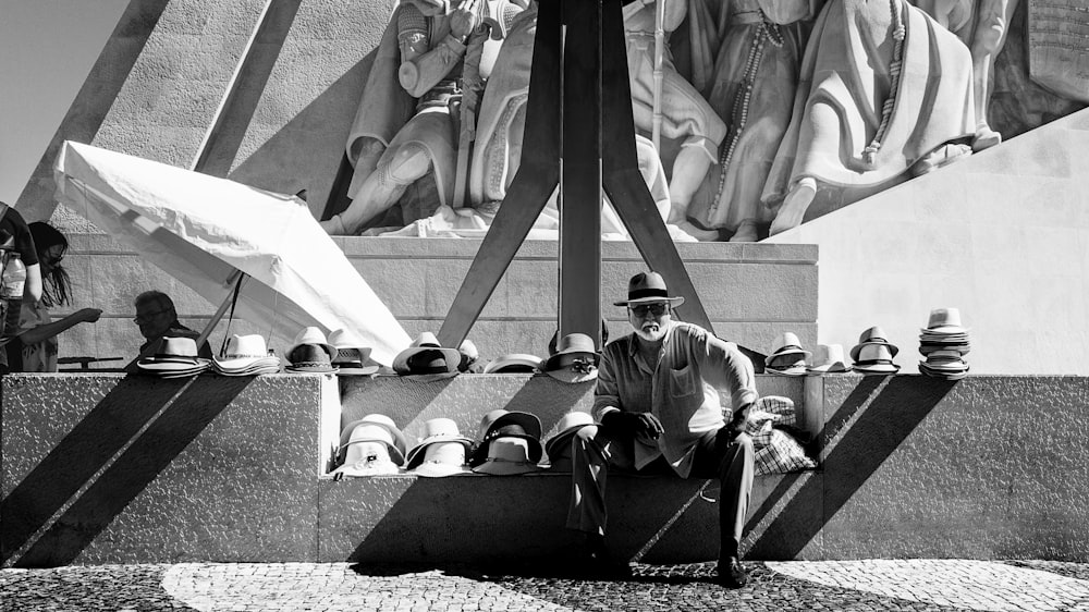 grayscale photography of man sitting