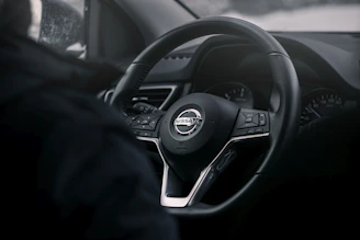 Close-up of a sleek Nissan Skyline GTR dashboard displaying Haltech tuning software in action.