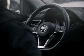 Close-up of a Nissan car dashboard showcasing its well-maintained interior.