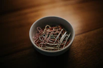 Close-up of shaped paper clips and metal clips arranged neatly on a light gray surface.