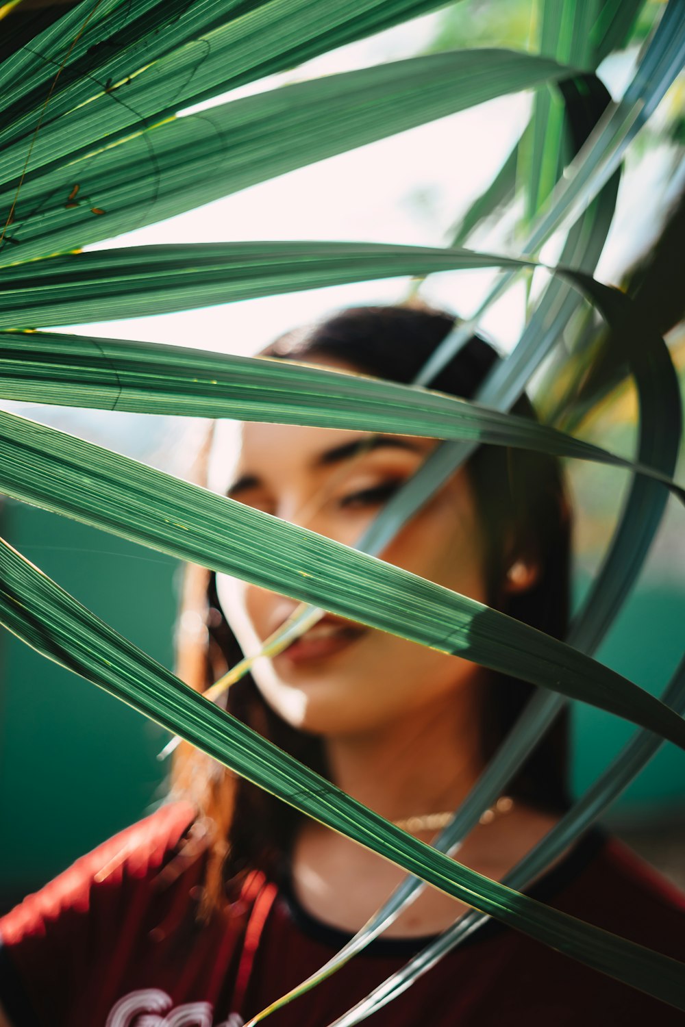 woman face with green-leafed plants