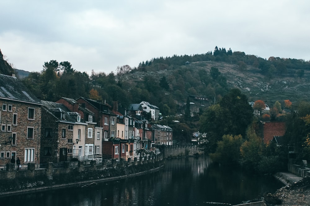 canal houses near mountain during daytime