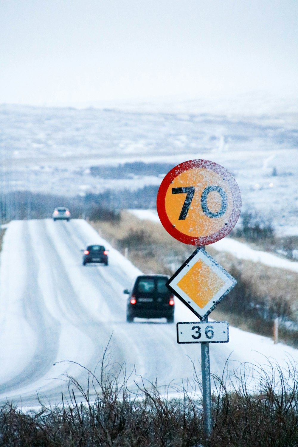 three vehicles running on road