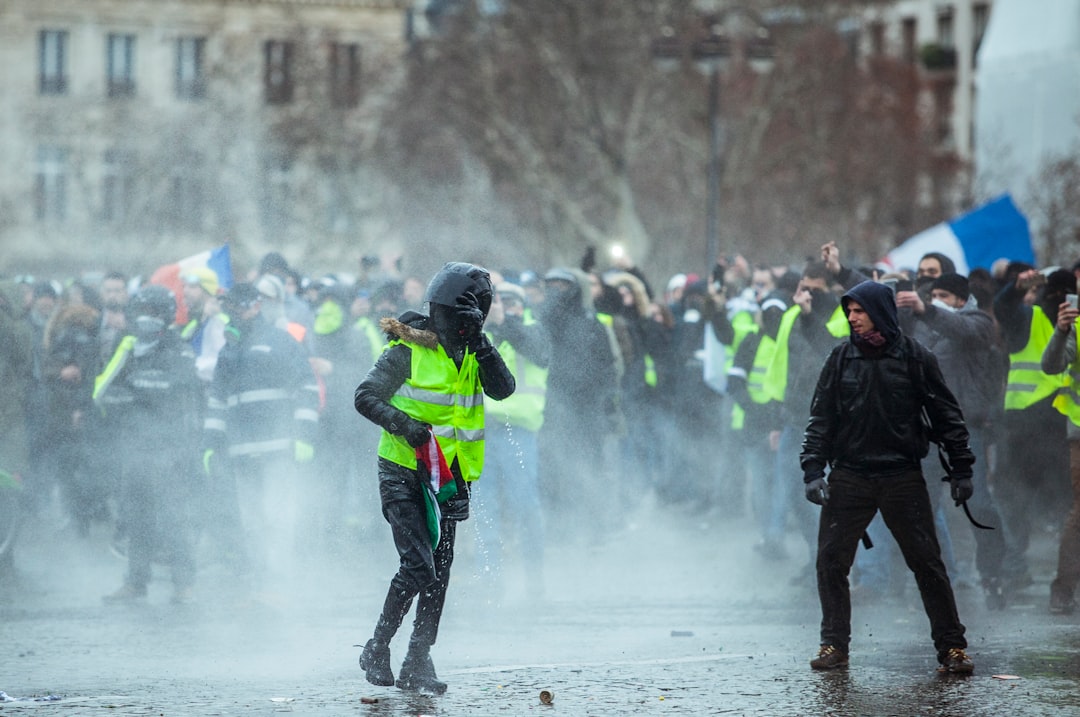 man standing in front of person wearing green reflector vest