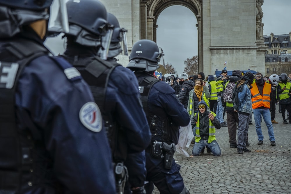 man kneeling in front of police