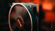 A close-up of a mini fan with vibrant colors against a bright background.