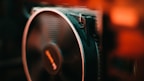 A close-up of a mini fan with vibrant colors against a bright background.