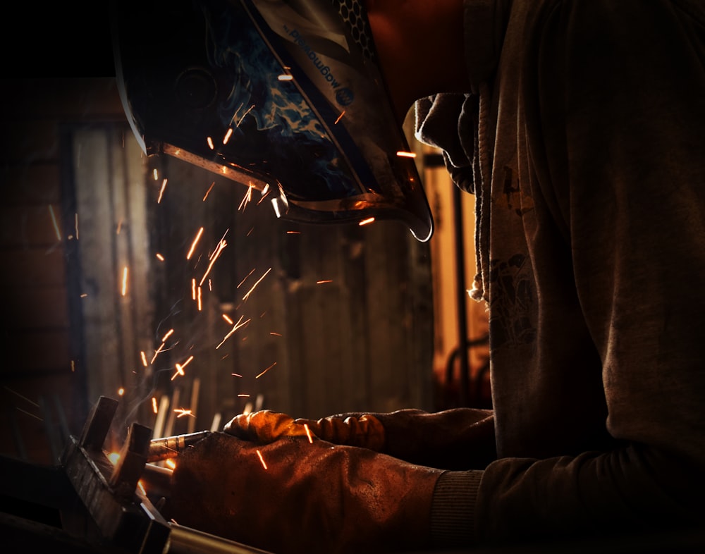 person welding wearing welding helmet