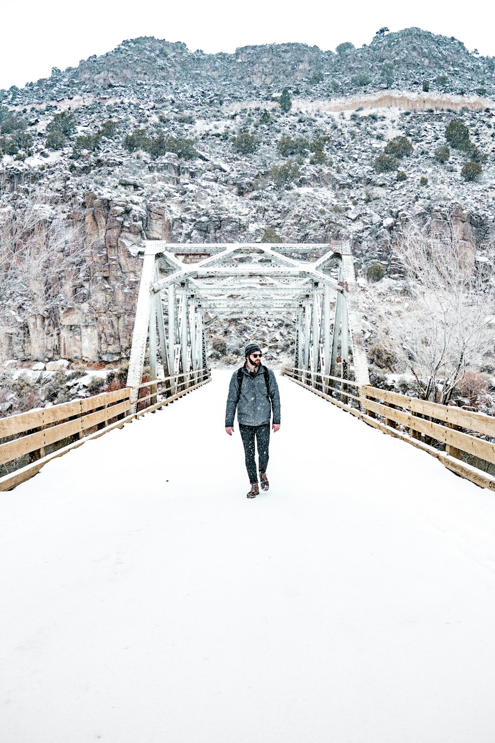 man walking on bridge during daytime