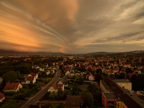 Before and after shots showing a roof transformation on a suburban home