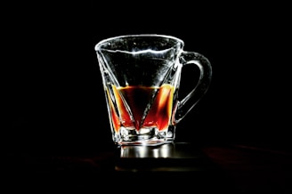 A sleek glass mug filled with steaming tea, showcasing its clear, minimalist design.