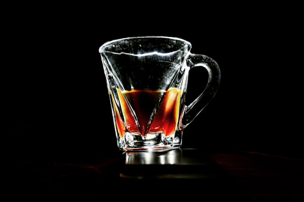 A sleek glass mug filled with steaming tea, showcasing its clear, minimalist design.