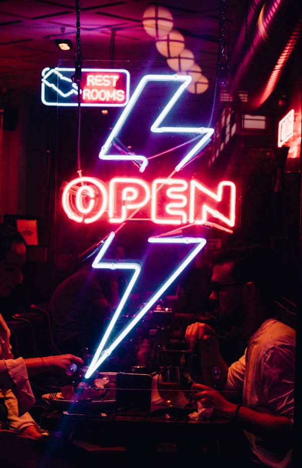 blue and red Open neon light signageby Liam Edwards
