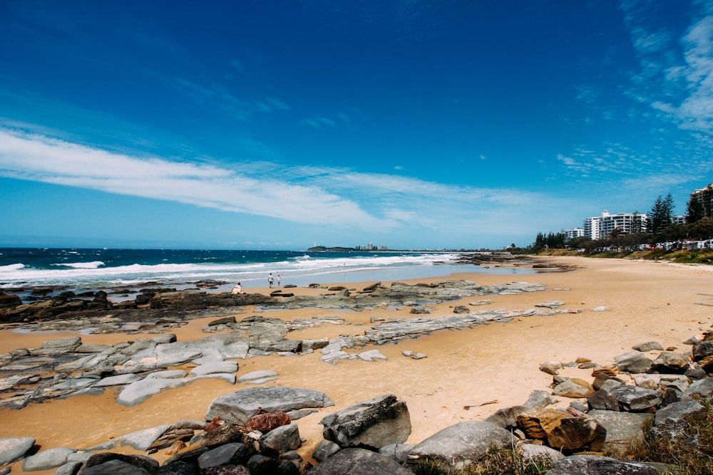 rocky shore under clear blue sky during daytime