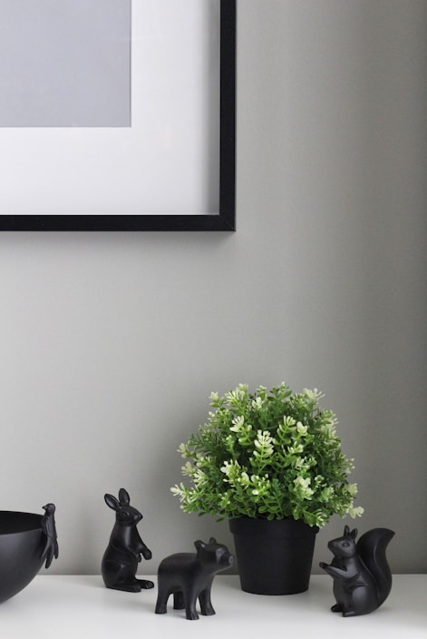 A minimalist gallery wall featuring neutral-toned printable art in a cozy living room setting