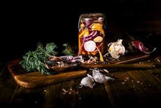 A minimalist kitchen scene with a small jar of tamari and fresh vegetables ready for cooking