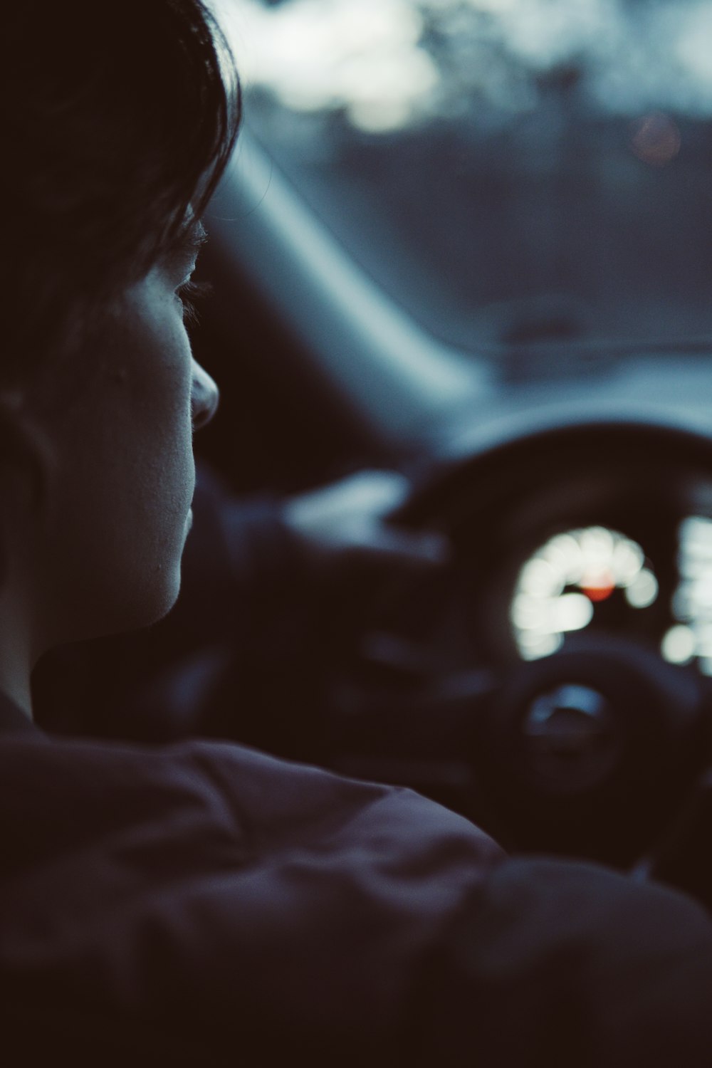 person sitting on driver's set inside vehicle