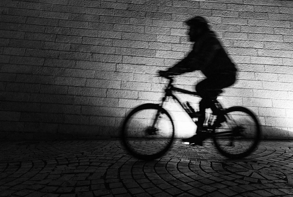 silhouette of biker inside tunnel
