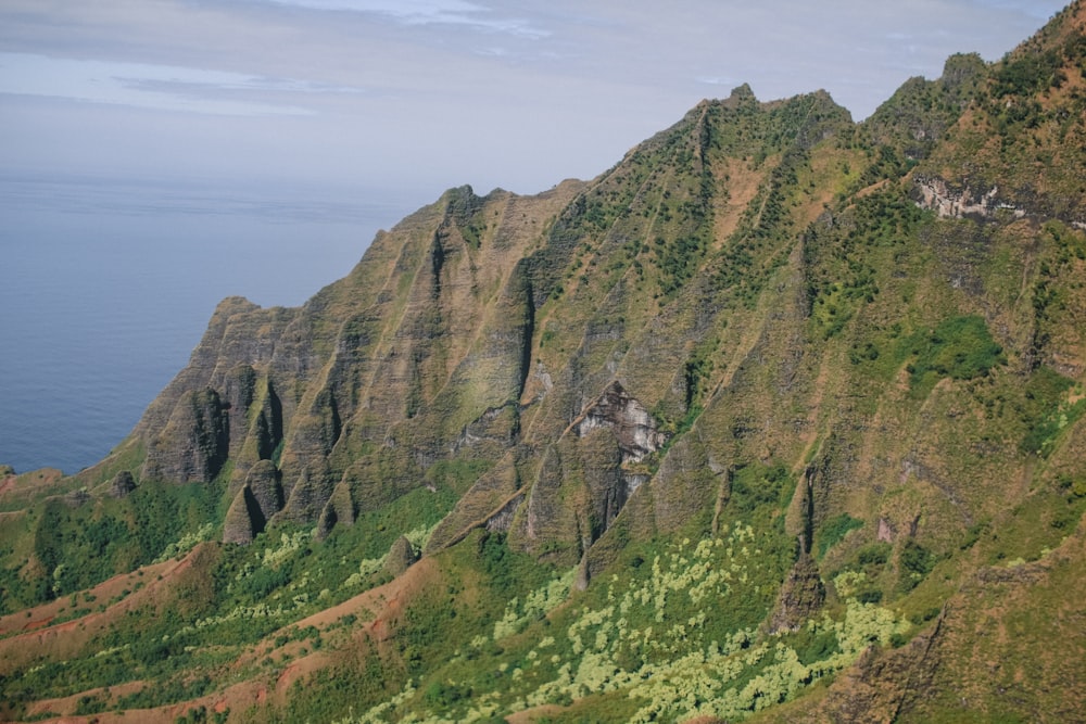 green mountain near sea during daytime