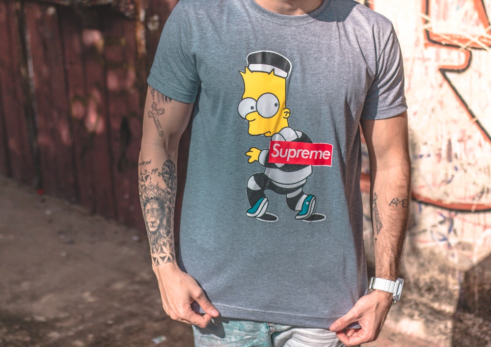 man wearing gray Supreme Bart Simpson crew-neck T-shirt