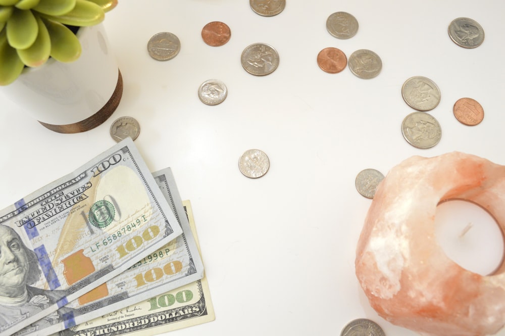 silver round coins on white table