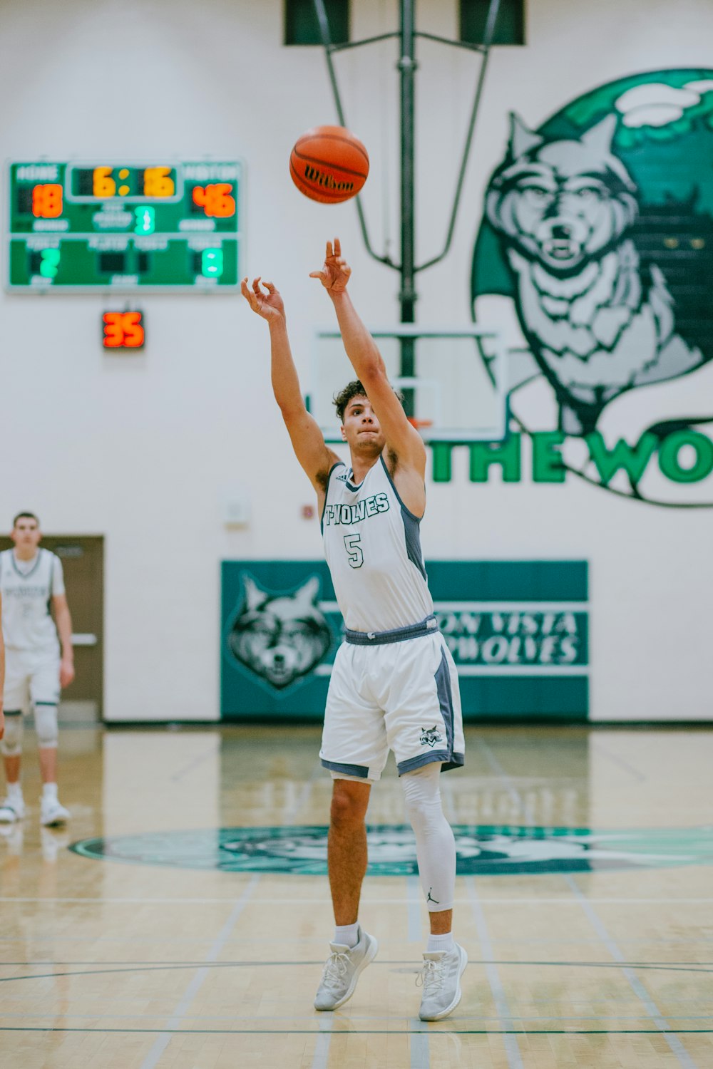 man throwing basketball inside court