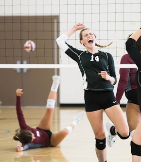 women playing volleyball inside court