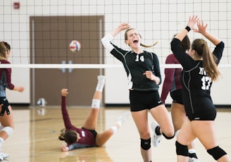 women playing volleyball inside court