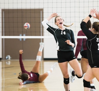 women playing volleyball inside court