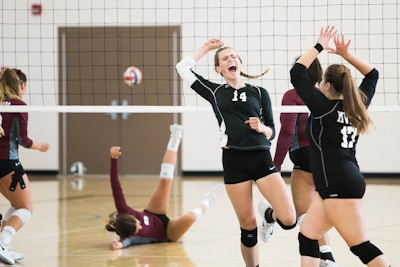 women playing volleyball inside court