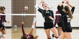 women playing volleyball inside court