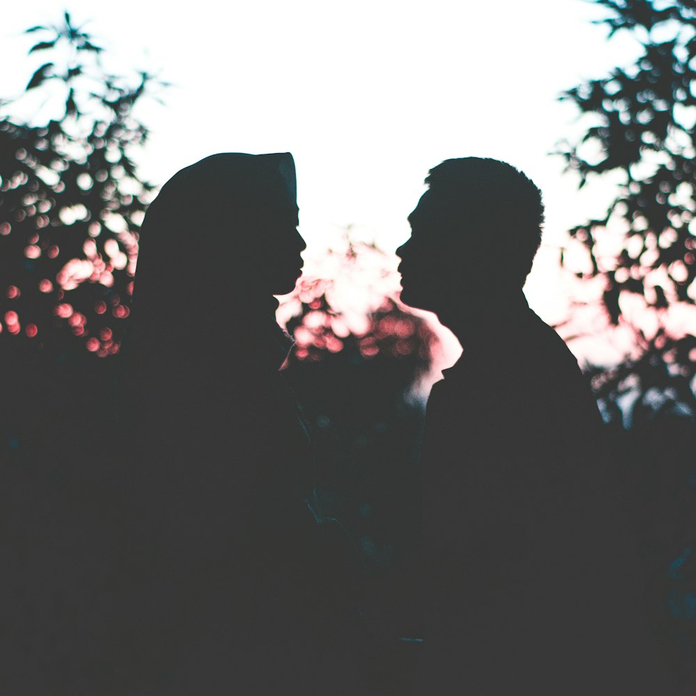 silhouette photo of man and woman facing each other