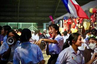 two women using megaphones beside crowd people