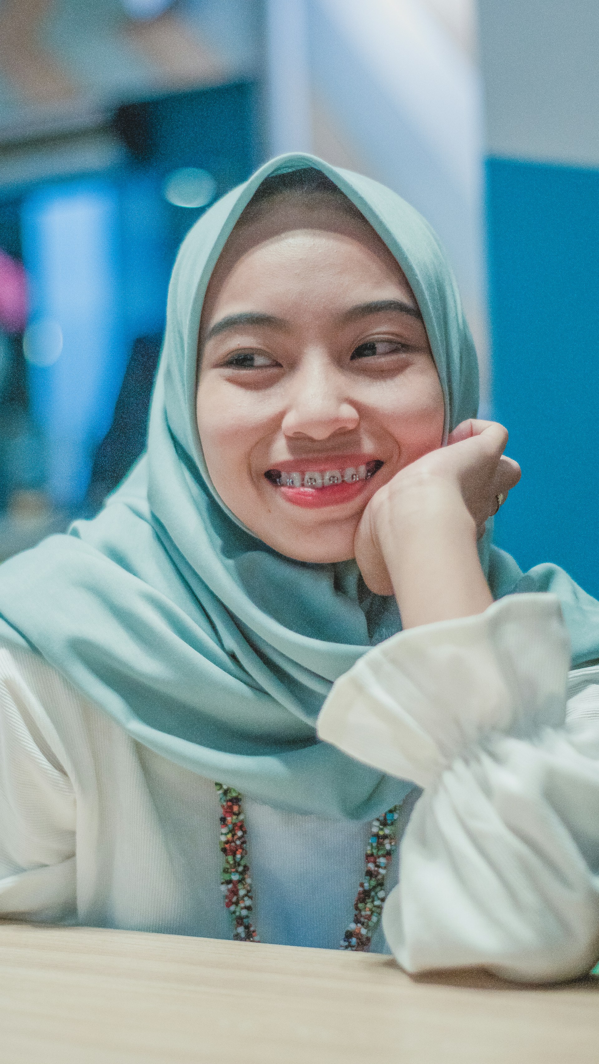 A close-up of Dr. Shabahat, a female dentist, smiling warmly while interacting with a patient, showcasing her friendly and professional demeanor.