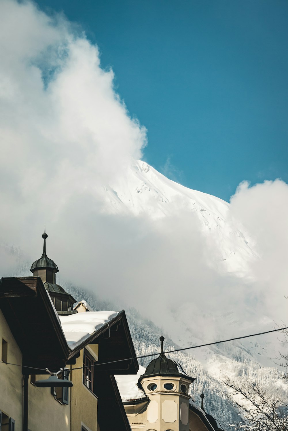 brown concrete house under white clouds during daytime