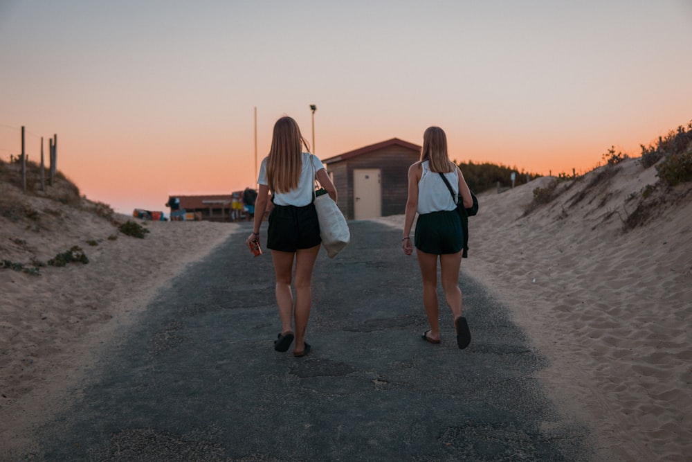 two women walking on alley