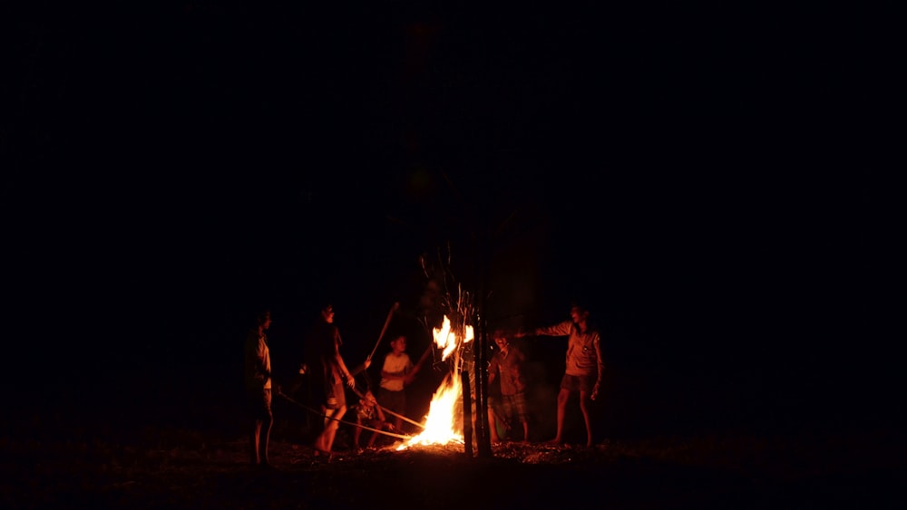 people surrounded bone fire